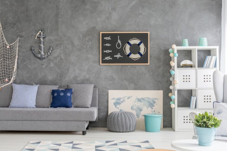 Grey Home Interior With Nautical Wall Decor Sofa Carpet And White Storage Unit 768x512 